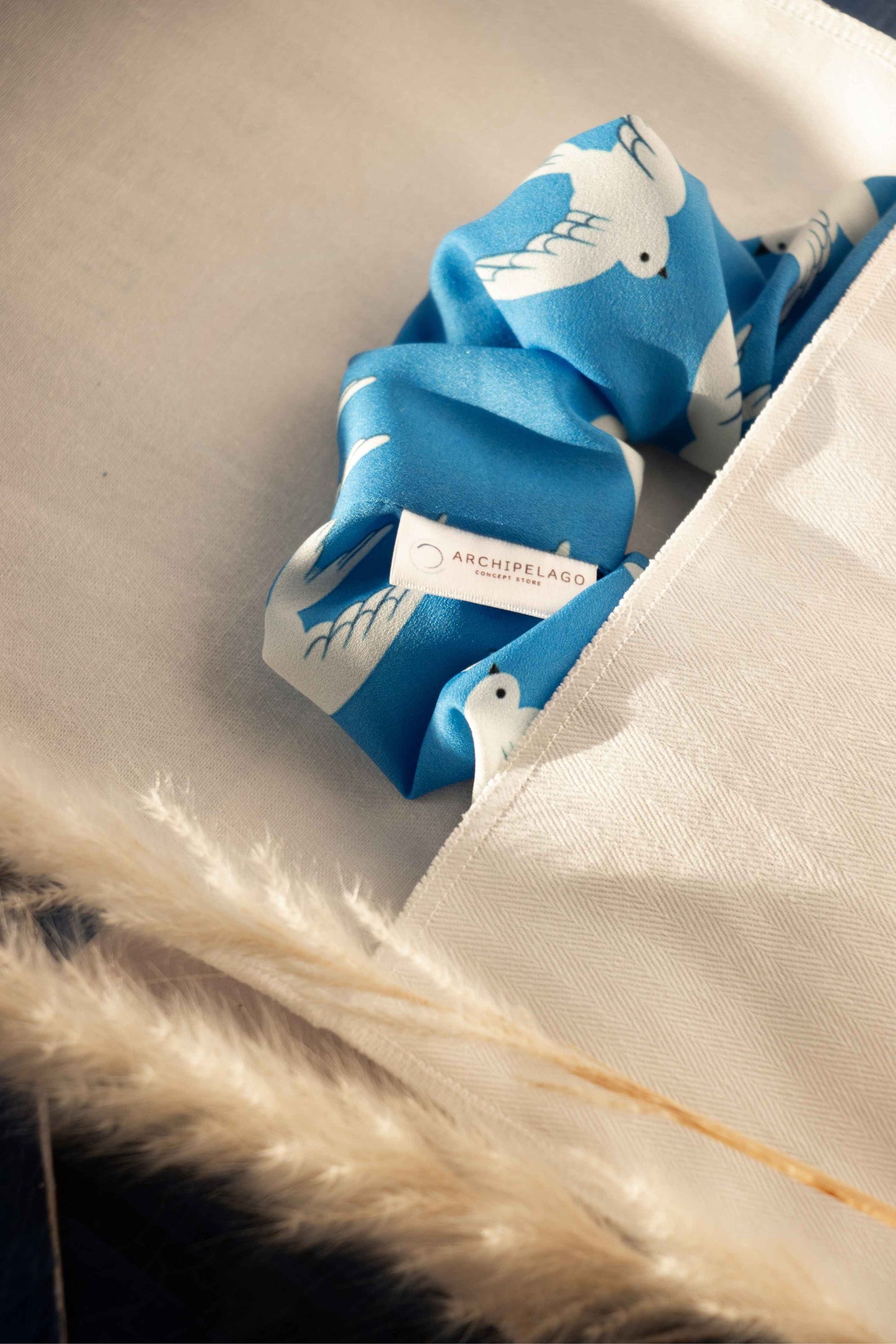 Coastal Wings Scrunchie on its cotton pouch
