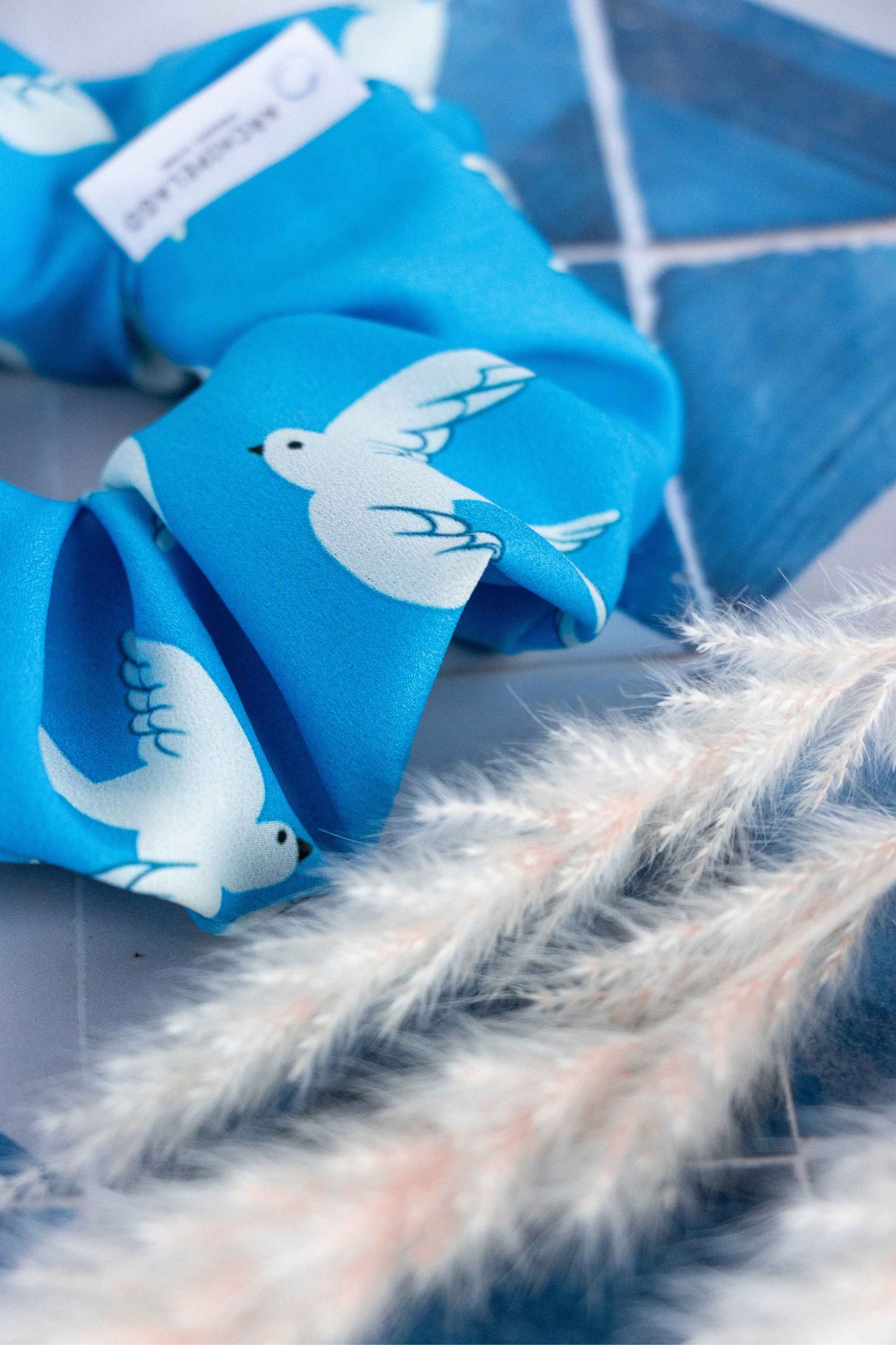 Coastal Wings Scrunchie Close Up to the label