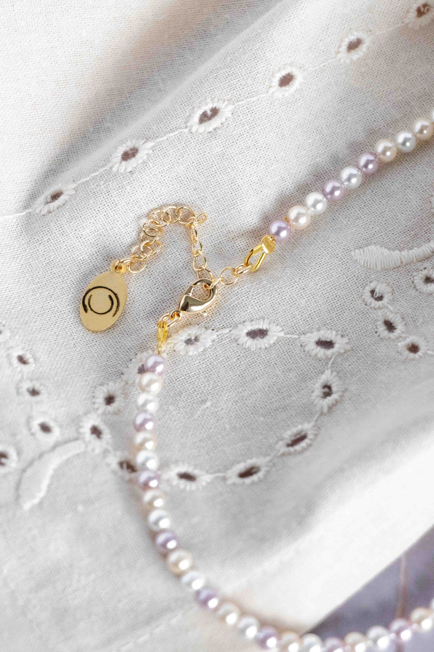 Pearl necklace close up to a gold clasp