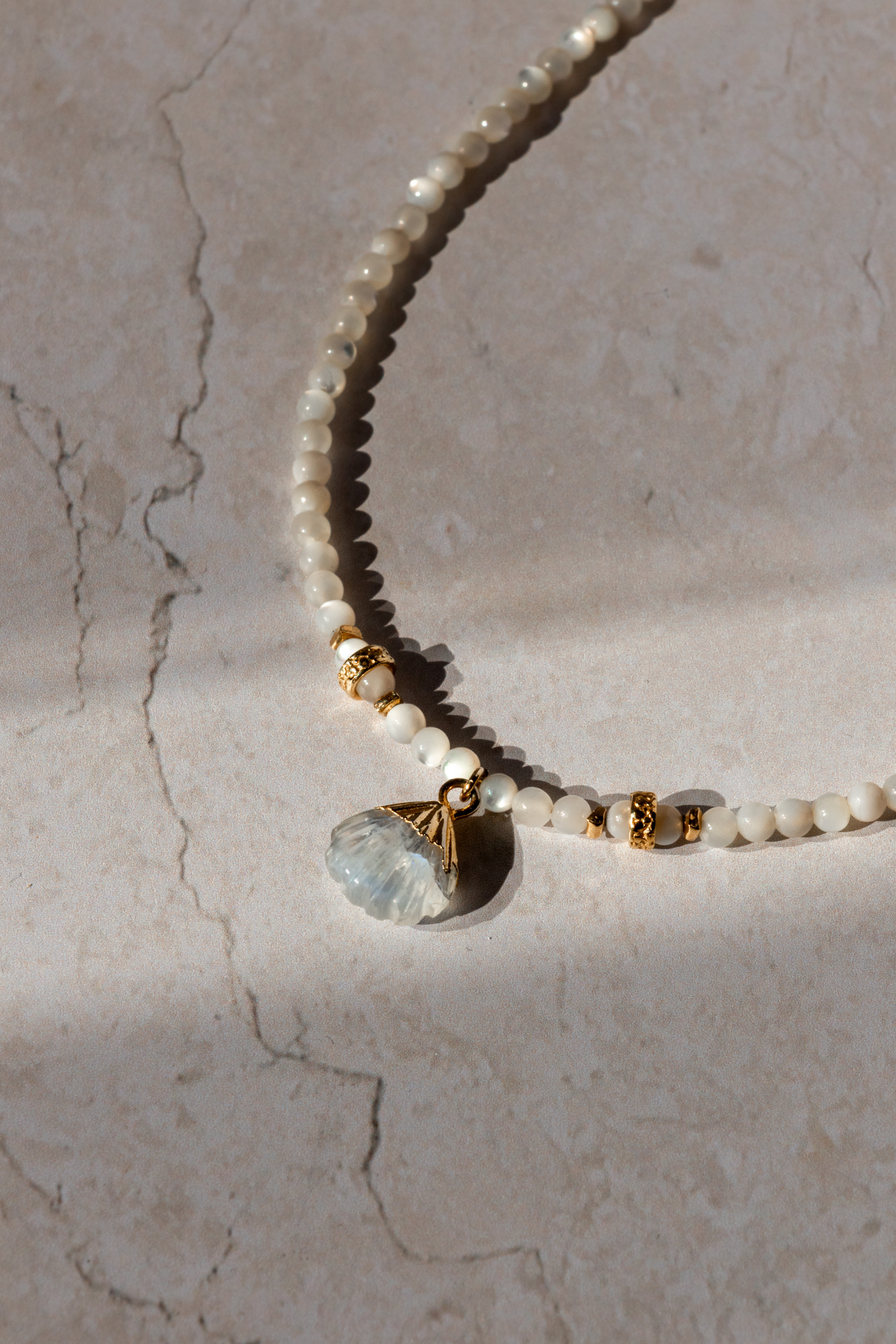 The cycladic Shell Neckace on a flat lay shot.