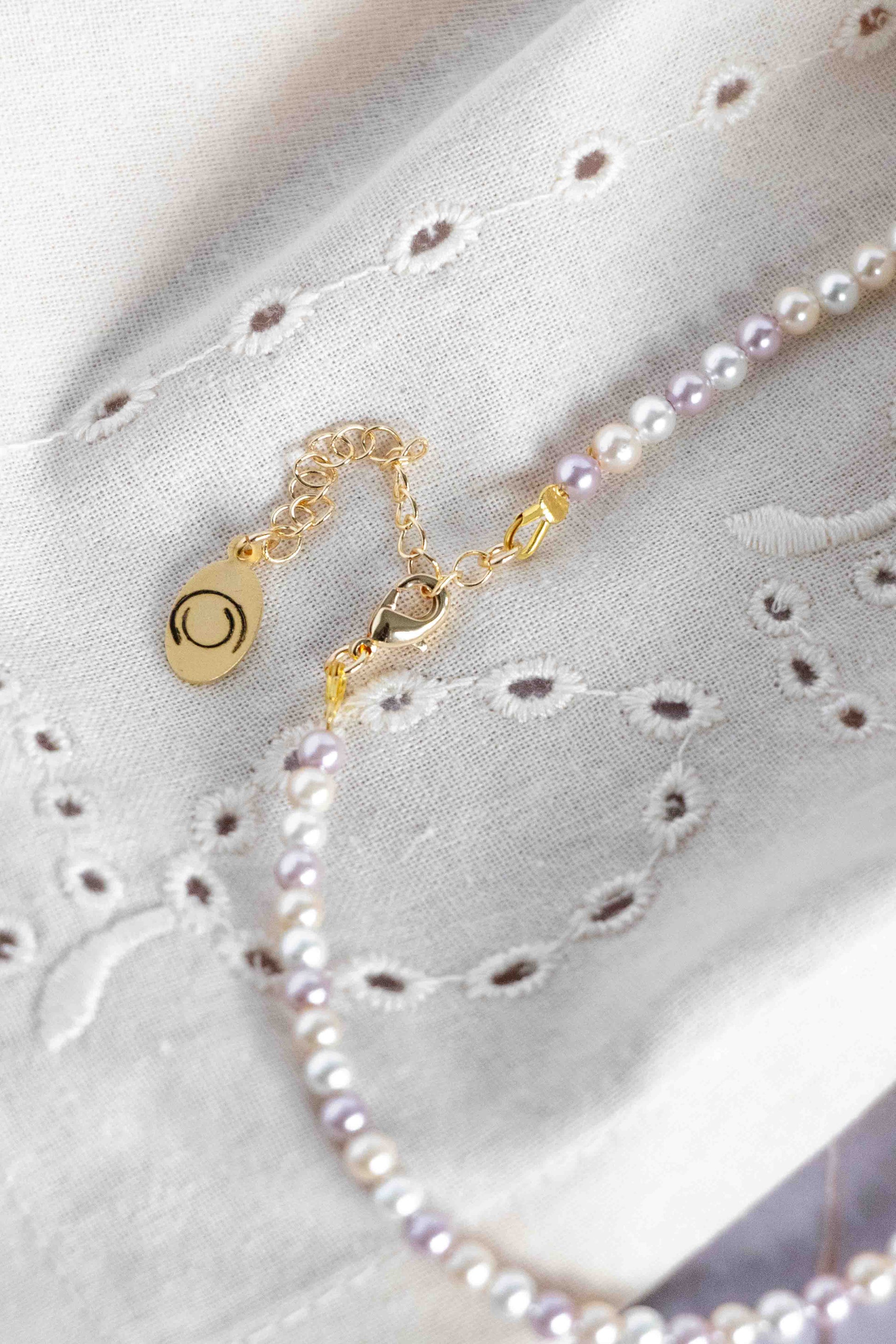 Pearl necklace close up to a gold clasp