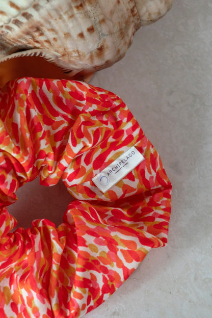 Colorful scrunchie with a brand label on a light background